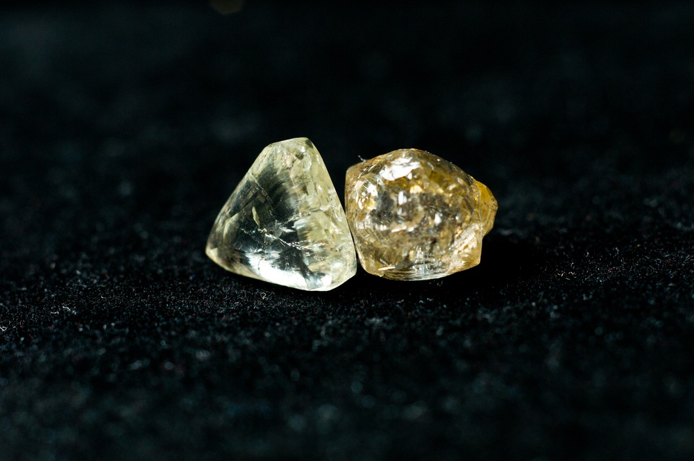 Rough diamonds often look like they are covered in oil. They get most of their sparkle from being cut and polished. (Farbled/ Shutterstock)