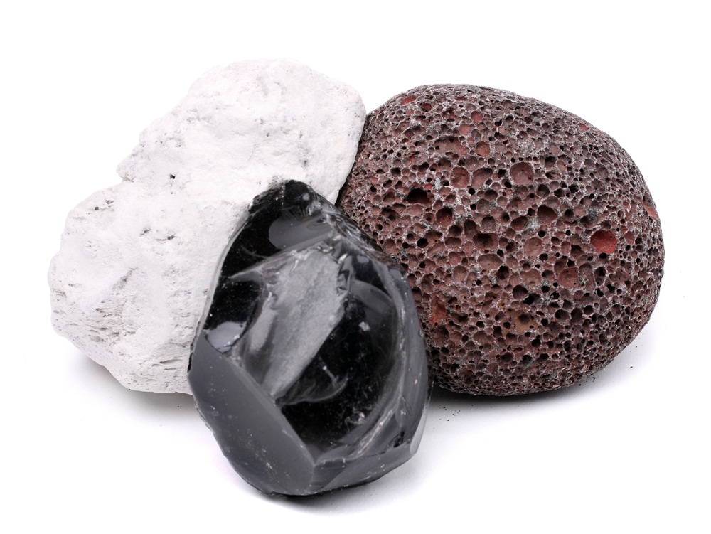 All three of these rocks are made of cooled-down lava. Obsidian is hard and smooth as glass, but the white and gray pumice stones are lightweight, rough, and porous. As fiery lava blasted out of a volcano, it hardened into pumice so quickly that it preserved the air pockets created by exploding gas bubbles. (Kletr/ Shutterstock)