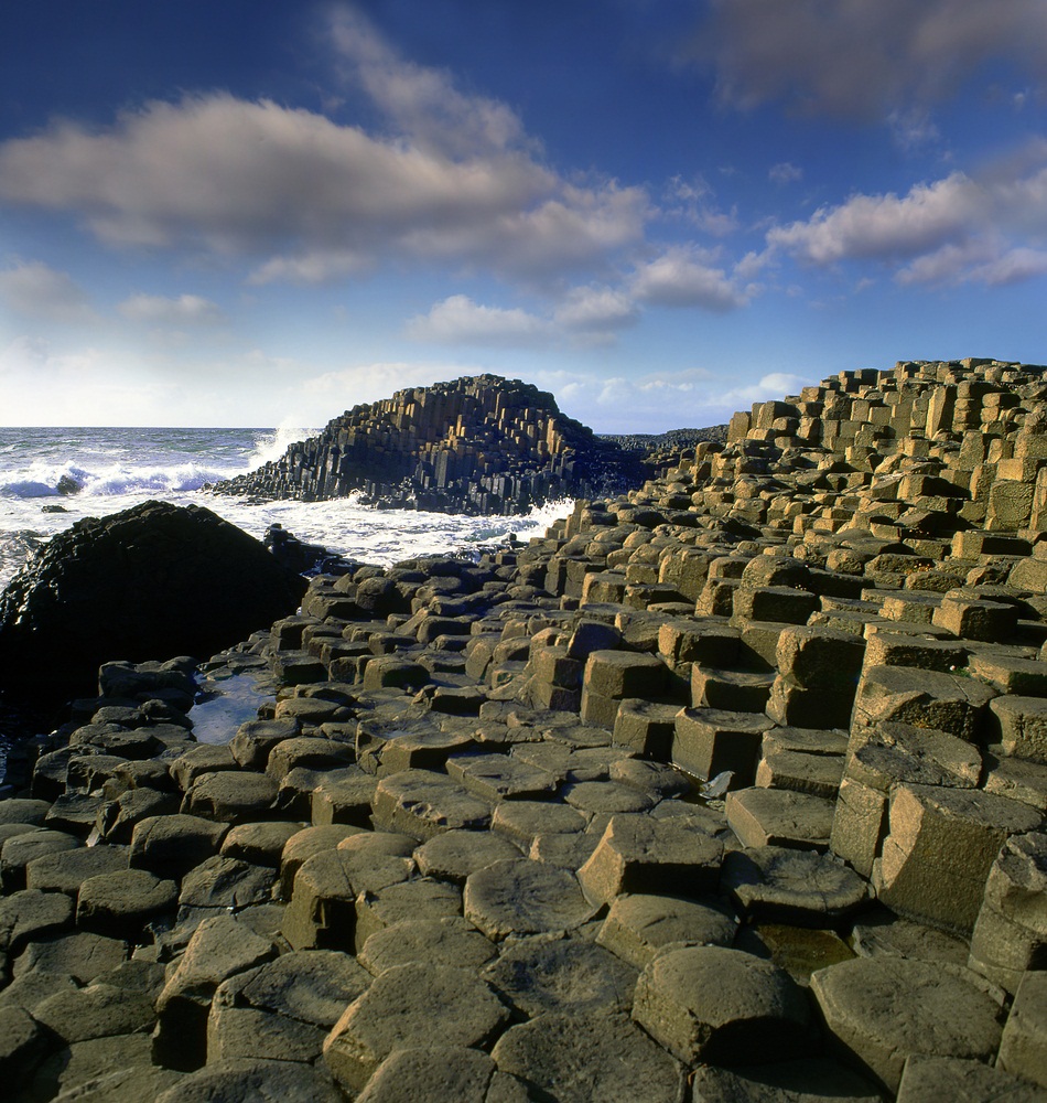 About 50 million years ago, a thick layer of lava poured onto the Earth’s surface. The lava cooled to form these polygon-shaped columns, now known as the “Giants Causeway.” Made of an igneous rock called basalt—the primary bedrock beneath the oceans—the columns eroded to form what look like paving stones leading across the sea from Northern Ireland to Scotland. (Pecold/ Shutterstock)