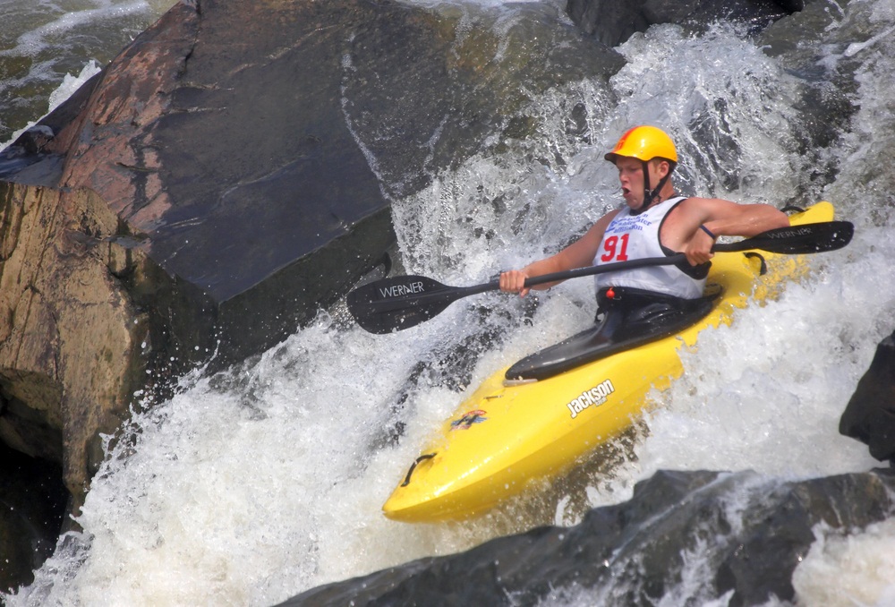 Another whitewater event is downriver racing. Run in wild rivers, these races can be as long as six miles through treacherous drops, waves, holes, and narrows. If kayakers take a tumble and hit a rock, padded helmets protect their heads. (2265524729 / Shutterstock.com)
