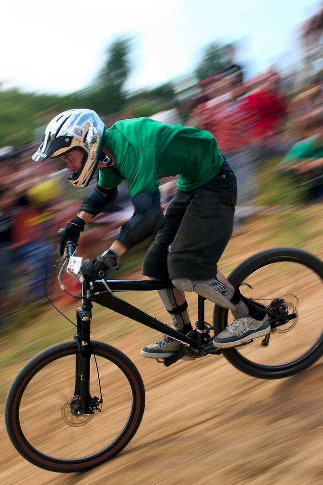 Downhill mountain bike racing can be blisteringly fast and jumps built into the courses send riders airborne. Wipeouts are common, so riders bulk up on protective gear. This downhill racer is wearing shin guards, knee pads, elbow pads, and a full-face helmet. (Andrey Khrolenok/ Shutterstock)