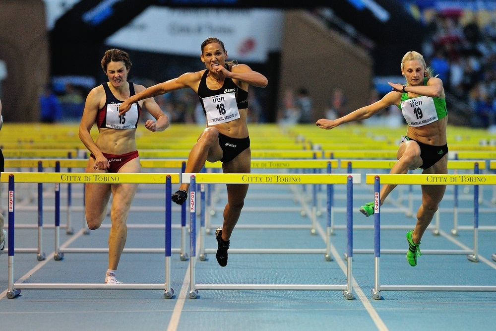 Olympian Lolo Jones (center) wins the 100-meter hurdles at an international competition. (Diego Barbieri/ Shutterstock)