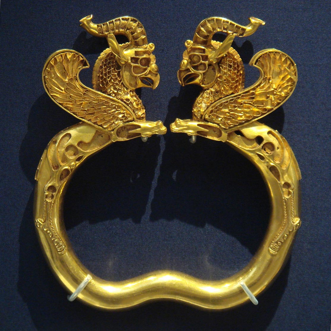 This gold bracelet was probably given as a gift of tribute to the royal court. It was one of about 170 gold and silver artifacts from the Archaemenid Empire found near the Oxus River in Tajikistan. The figures are two griffins, powerful mythical creatures, with the heads of eagles and bodies of lions, that the Archaemenids believed provided protection against evil.  (Photo via Wikipedia) 