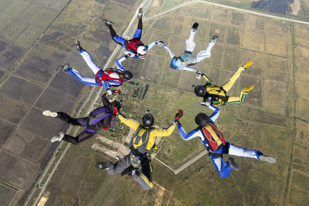 These skydivers are in “free fall.” After jumping out of a plane from two-and-a-half miles up, they are being pulled back to Earth by the force of gravity. Before opening their parachutes, the only thing slowing their fall is “air resistance.” These sky divers will never fall faster than about 120 mph. But if one of them went into a “diving” position and reduced air resistance, that skydiver could reach a top speed of about 200 mph. When you are in free fall, you feel weightless. (Shutterstock / Germanskydiver)