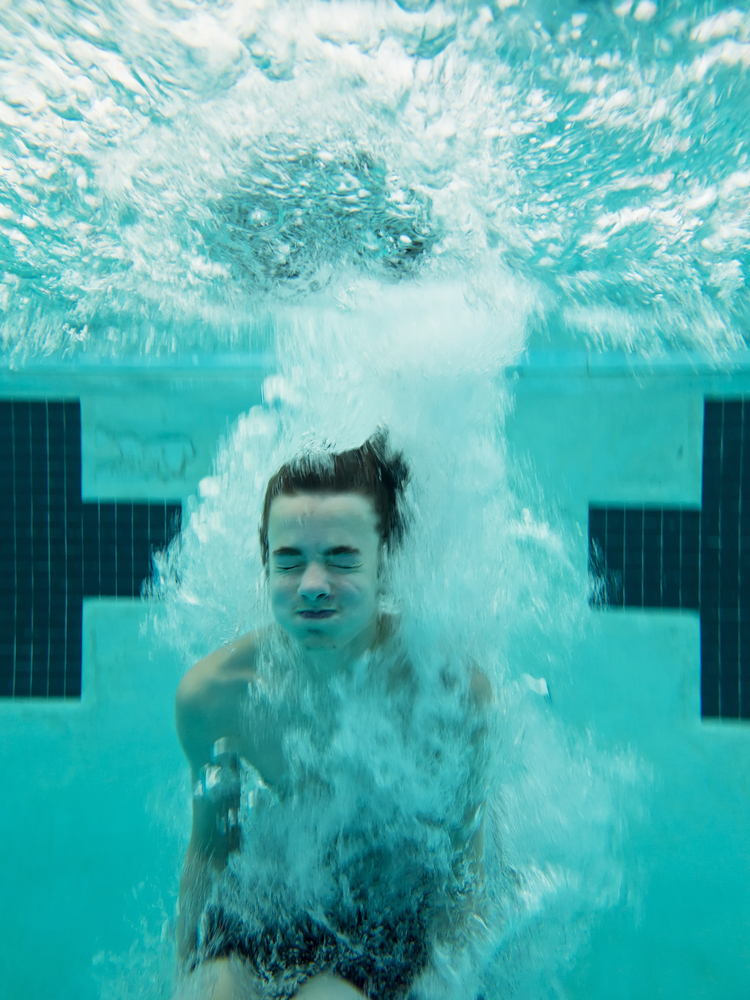When you cannonball into a pool, you create a huge splash. The force of your body hitting the water is what puts the water in motion. (Shutterstock / John Wollwerth)