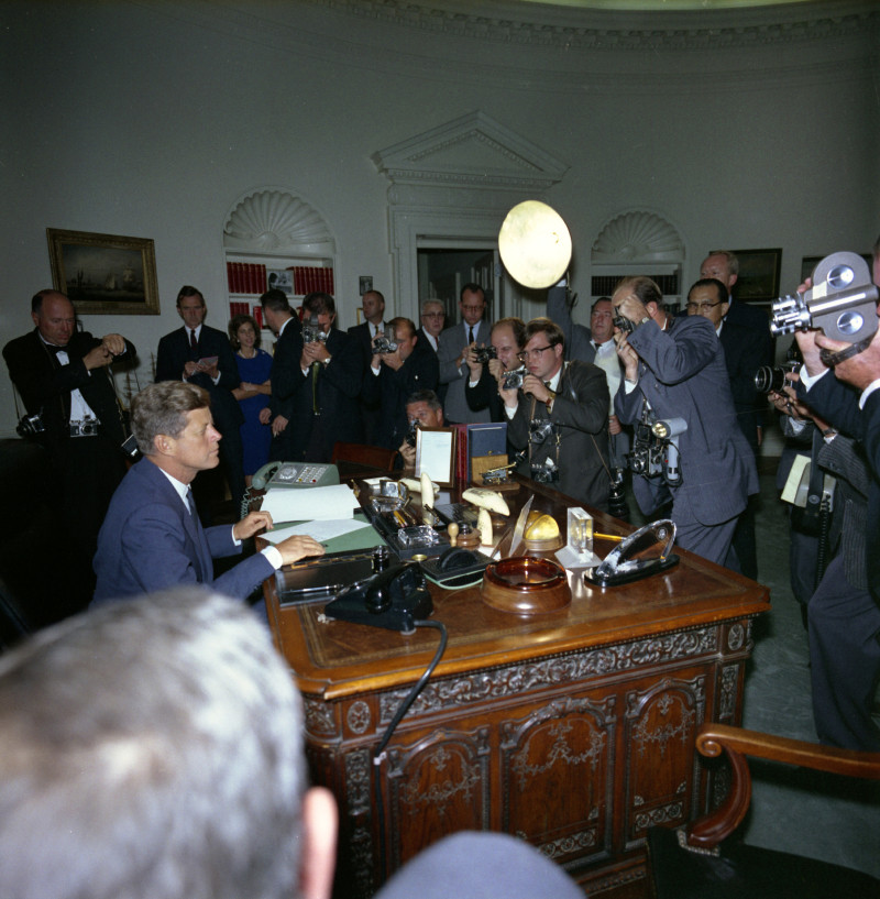 In one of the tensest moments of his presidency, JFK signs the order to set up a naval blockade around Cuba during the Cuban Missile Crisis in October 1962. (Robert Knudsen / John F. Kennedy Presidential Library and Museum)