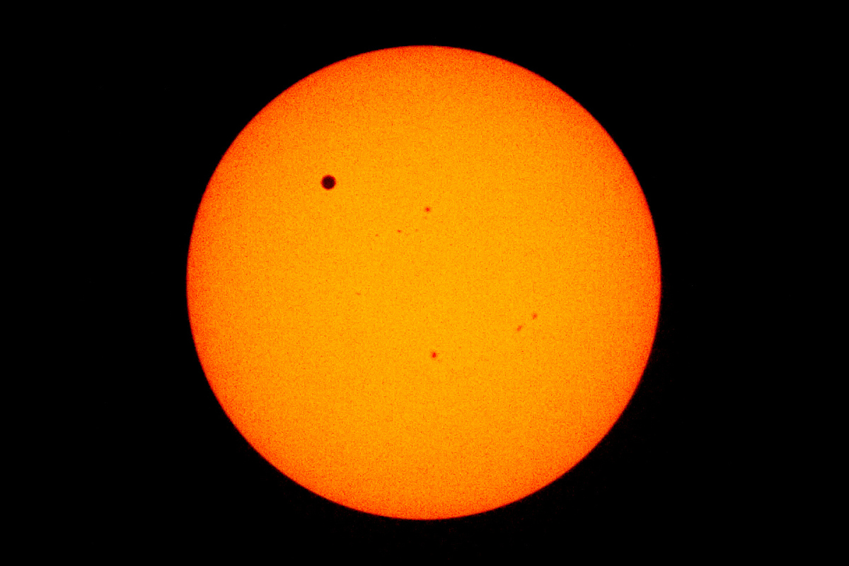 This photograph shows Venus transiting in front of the sun in June 2012.  Transits like this, of planets passing in front a sun, actually reduce the brightness of the sun by a small but measurable amount. The picture was taken from the International Space Station.   (NASA)
