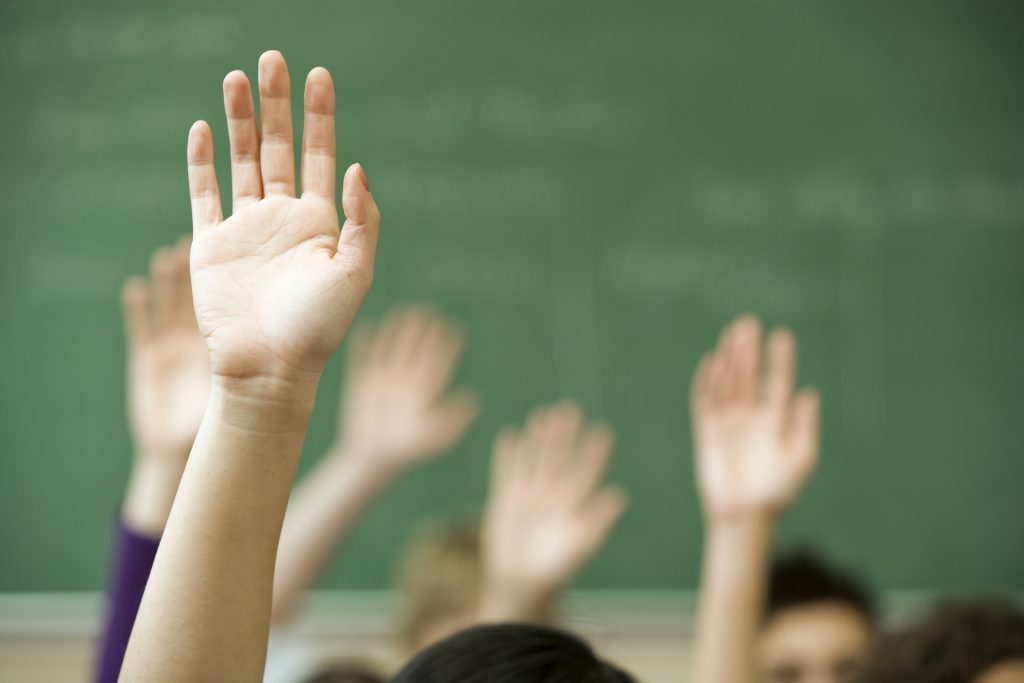 Hands raised in classroom